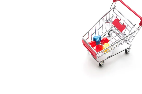 Miniature house and shopping cart on white background : economy — Stock Photo, Image