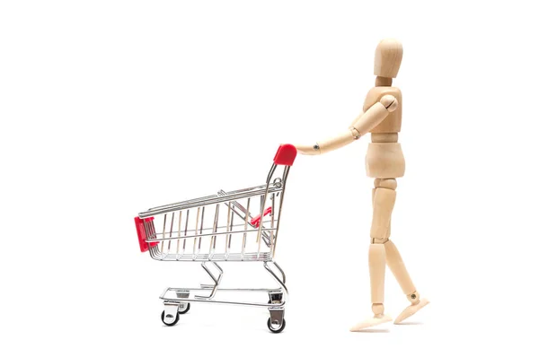 Muñeca de madera y carrito de compras sobre fondo blanco: conc economía —  Fotos de Stock
