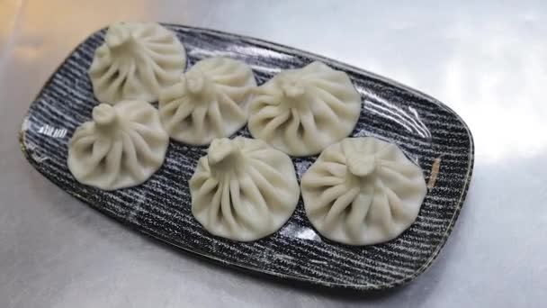 Close up of spinning plate of delicious khinkali dumplings — Stock Video