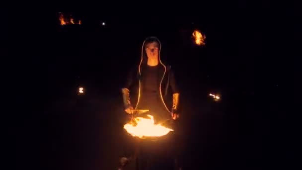 Man plays burning drum. Against the backdrop of flashing lights — Stock Video