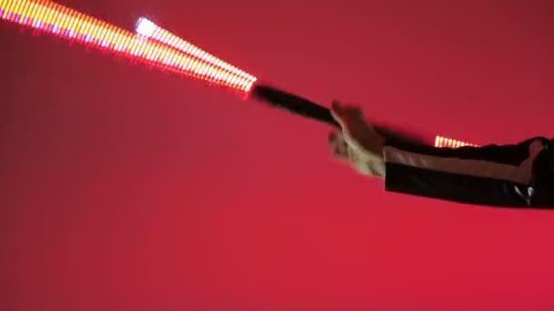 Led Show. Close-up of a man twists in his hand the LED stick that glows — Stock Video