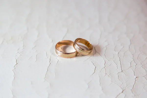 Wedding rings on an old leather couch and small cracks Stock Picture