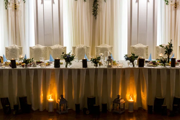 Beautiful wedding table for newlyweds is illuminated by candles Stock Picture