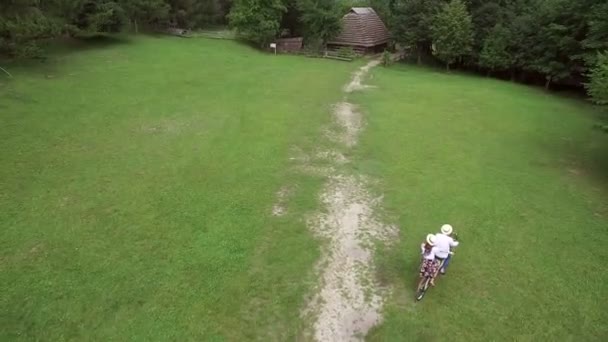 Aerial shot. Man and a woman riding a bike tandem. — Stock Video