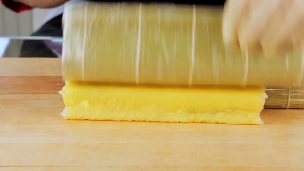 Maître préparant des rouleaux de sushi à l'aide d'un tapis de bambou et d'algues nori — Video