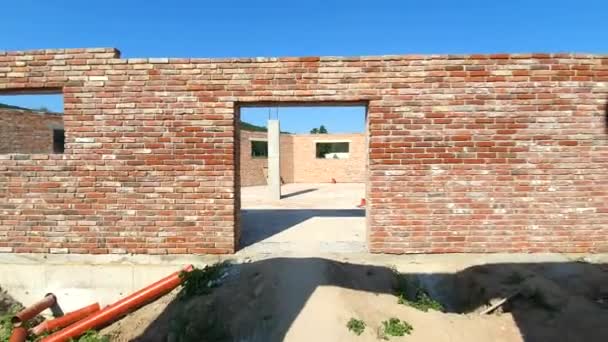 Das Gebäude aus rotem Backstein wurde nicht fertiggestellt. ein Zimmer in einem unfertigen Haus. — Stockvideo