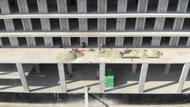 Aerial view Workers pour cement into concrete mixer — Stock Video