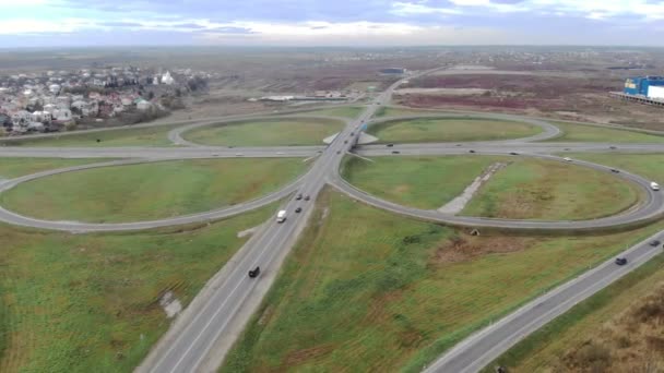 Aerial view from road and road junctions. Entrance to the city through the ring road. Cars are moving on the road. — Stock Video