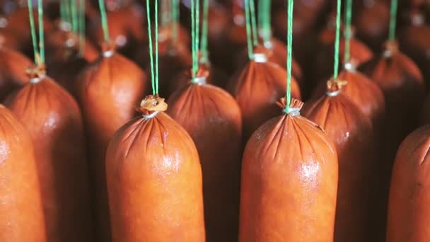 Sausage close - up which is suspended on the shelves, dries in the storage room. Panorama of the sausage which is suspended on laces in the refrigerator. — Stock Video