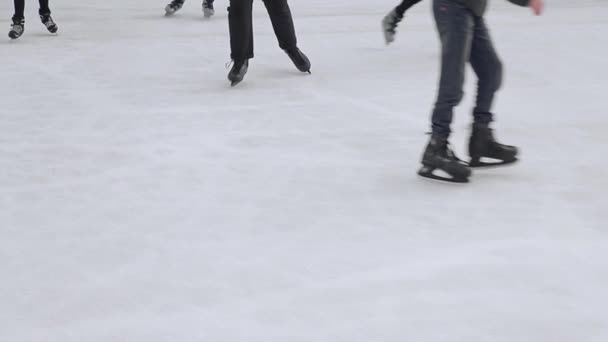 Turister åker närbild på en stor skridskobana. Fötter efter skridskoåkning som skridskor på en frusen sjö. — Stockvideo