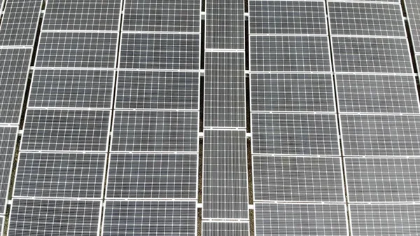 Aerial view Panorama of solar panels. Slow movement of the camera over the panels. Background