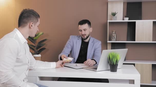 Cliënt biedt steekpenningen aan aan een werknemer van het bedrijf in het kantoor. De bedrijfsleider weigert steekpenningen die de weigering met zijn handen aantonen. — Stockvideo