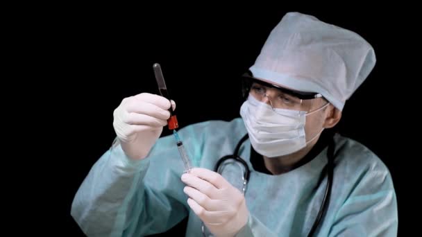 Doutor no laboratório, tira sangue de um tubo de teste para uma seringa para análise de sangue. Exame de sangue para o coronavírus Covid19 — Vídeo de Stock