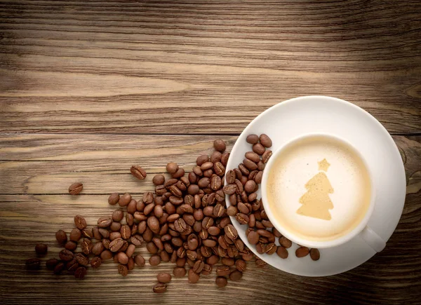 coffee cup with drawing christmas tree on wooden table