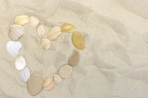 Heart on Sea Sand from pebbles and shells for background — Stock Photo, Image