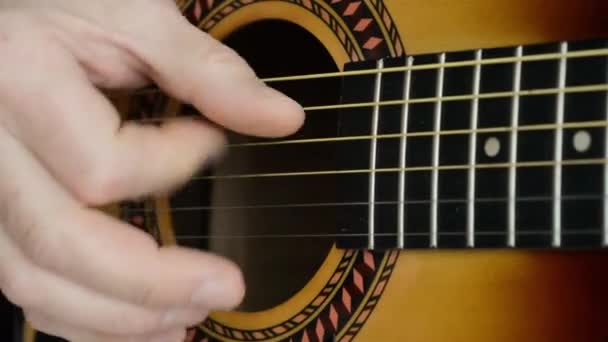 closeup footage of a man playing an acoustic guitar