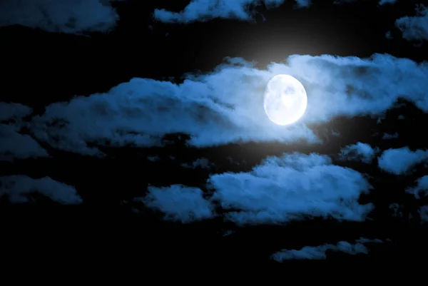 Night sky and a moon in the clouds Royalty Free Stock Images