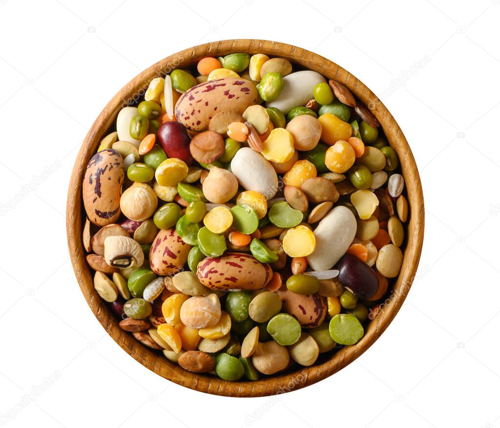 Various dried legumes in a small wooden bowl top view isolated on white.