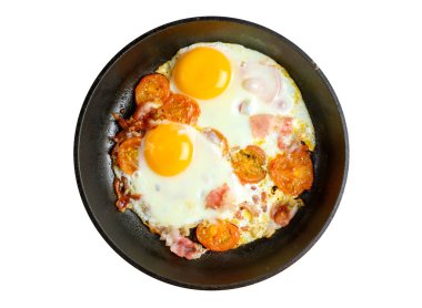 Fried eggs and bacon with tomatoes on frying pan isolated on white