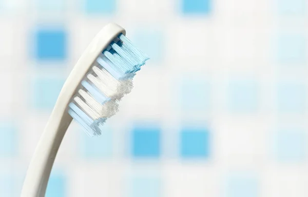 Toothbrush close-up on blue blurred background. Copy space — Stok fotoğraf