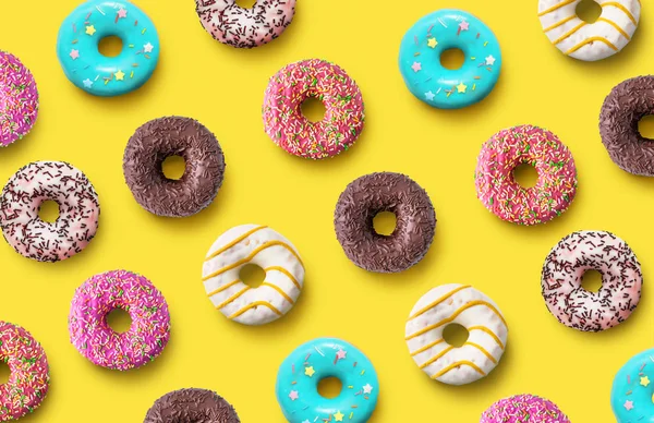 Delicious donuts pattern on a yellow background. Top view. Flat lay. Summer concept — Stockfoto