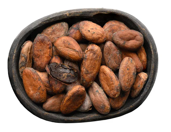 Frijoles de cacao en un tazón de madera viejo hecho a mano aislado en blanco. Vista superior —  Fotos de Stock