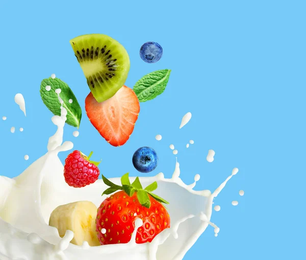 Fruit and berry falling in milk and splashing isolated on blue background. Smoothie or milkshake prepearing. — Stock Photo, Image