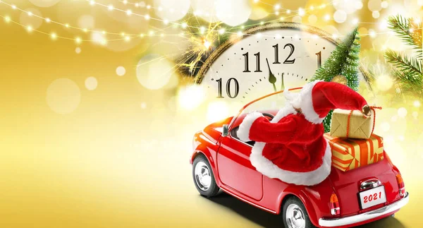 大晦日2021カードの背景。サンタクロースはギフトボックスとクリスマスツリーで赤い車を運転します。 — ストック写真