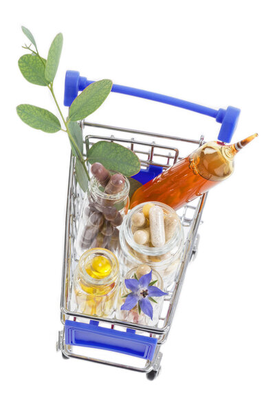 Shopping cart full of pharmaceutical drug ,medicine pills ,plants and food supplement