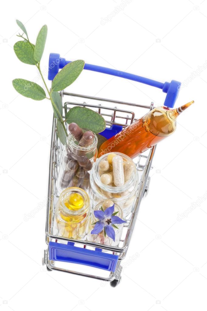 Shopping cart full of pharmaceutical drug ,medicine pills ,plants and food supplement