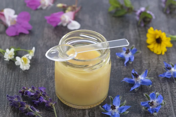 Raw organic royal jelly in a small bottle — Stock Photo, Image