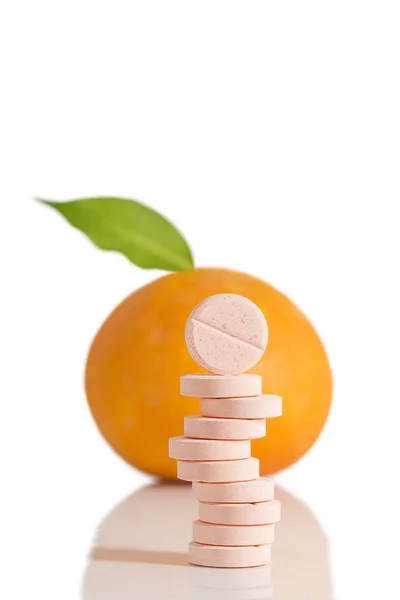 Vitamin c tablet stack with orange fruit whole — Stock Photo, Image