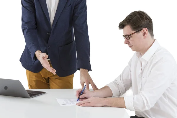 Two young businessmen signing contracts at office desk — Stock Photo, Image