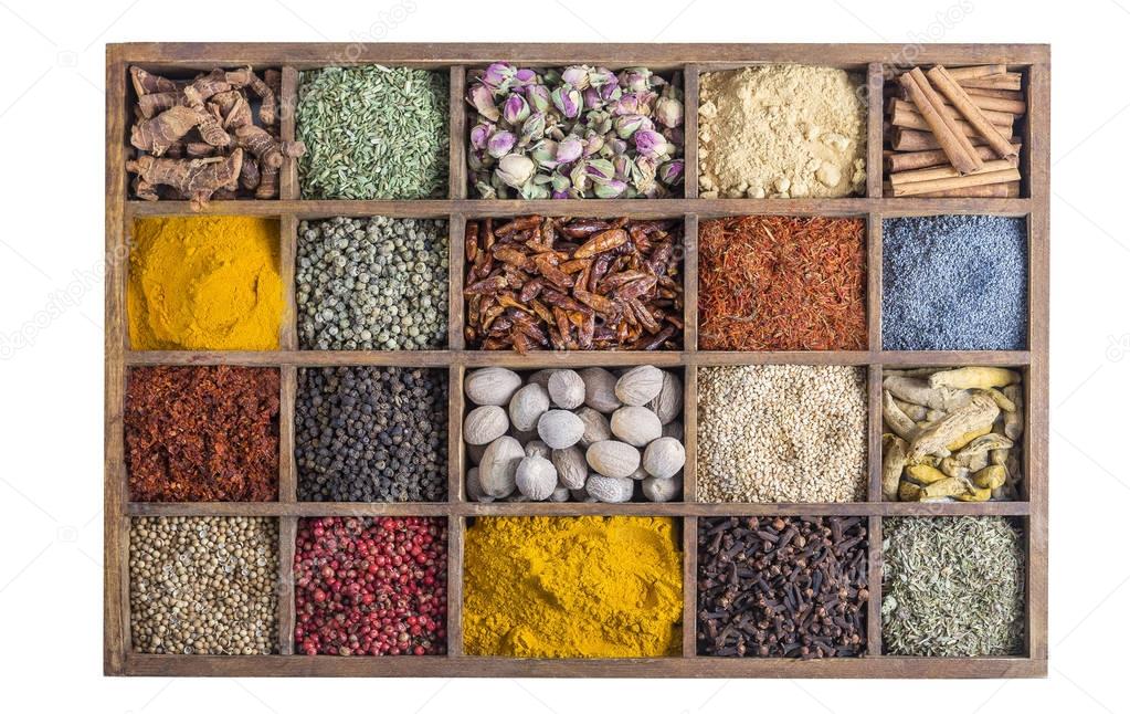 wooden box with spices and herbs on white