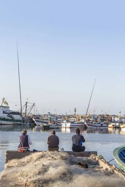 Houm Souk família pegar peixes da costa com o porto e barco de pescador no fundo — Fotografia de Stock