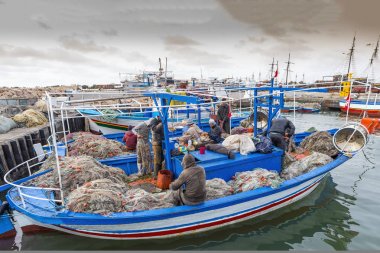 March 24 2017 Houm Souk, Tunisia,Beautiful fishing boat with a large fishing net in it.North Africa in spring clipart