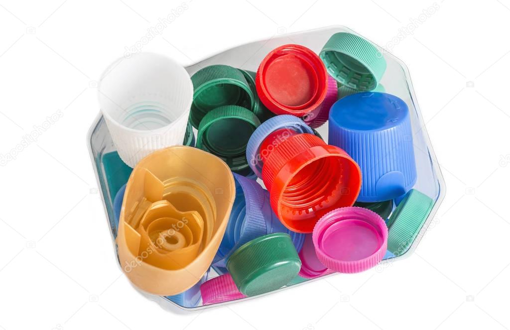 collection of many plastic caps for recycling on white