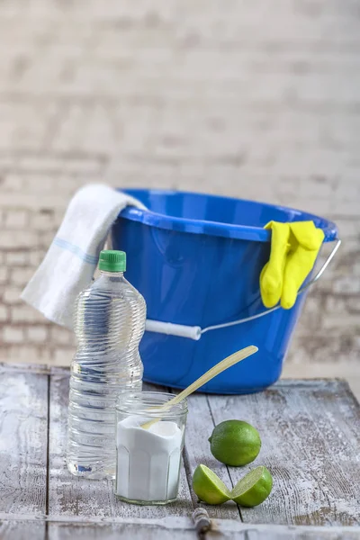 View of baking soda with ,blue, bucket, mop, gloves, lemon, vinegar, glove, natural mix,for effective house cleaning,on wooden floor green cleaning concept — Stock Photo, Image