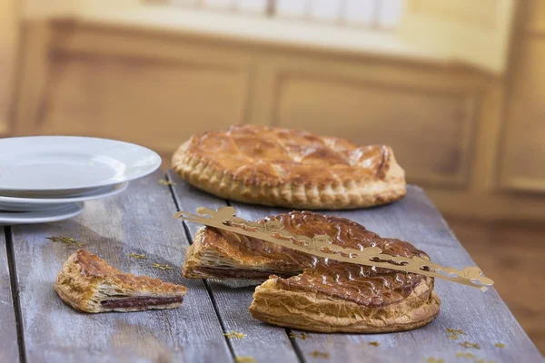 Pastel de Galette des Rois. Pastel tradicional de Epifanía francesa con almendra sobre tabla de madera gris sobre fondo de ventana . — Foto de Stock