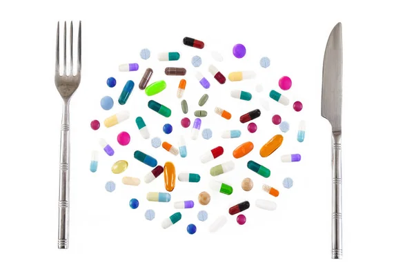 Sağlıklı beslenme kavramı, farklı türleri ve renkleri ile ilaç. Tabletler ve pils. Gümüş çatal ve bıçak — Stok fotoğraf