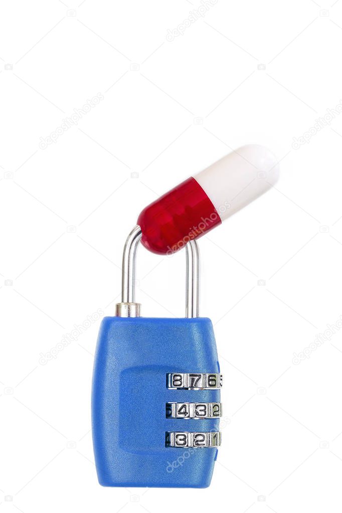 drug capsule red and white trapped in a blue metal padlock on white background copy text