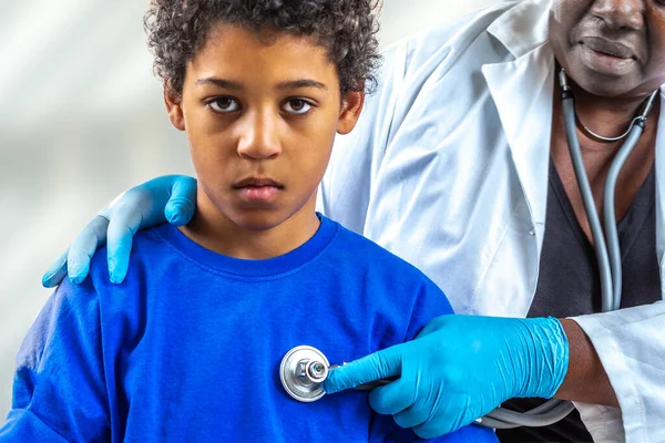 Médico examinando al niño pequeño listhening su pulmón en la visita al hospital —  Fotos de Stock