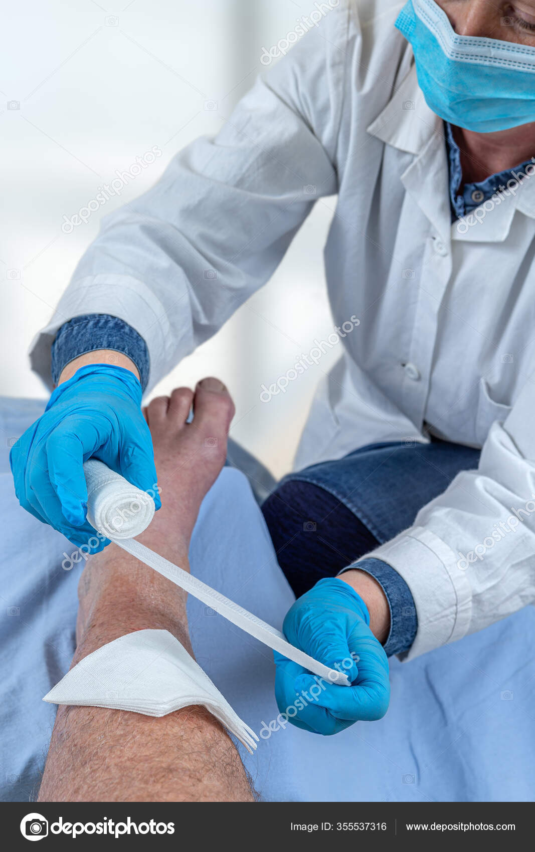 Man Leg Hurts Patient Receiving First Aid Nurse Bandaging Wound ⬇ Stock