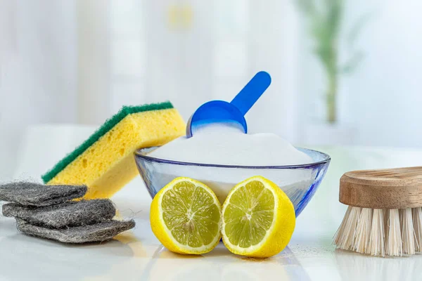 Eco-friendly natural cleaners Concept: Naturel cleaning products against chemical detergent bottles, vs backing soda powder, lemon, and brush