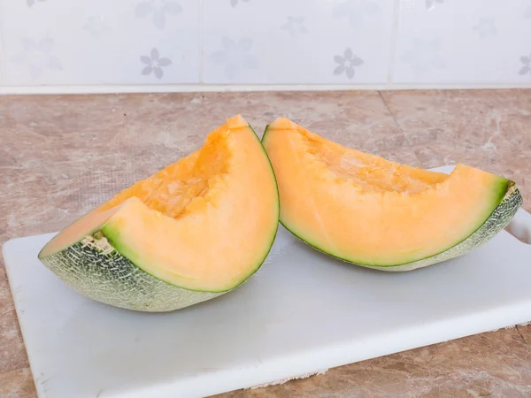 Mutfakta beyaz bir blok üzerinde turuncu Japon kavun