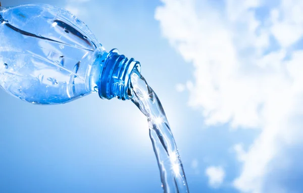 Water pouring from plastic bottle. — Stock Photo, Image