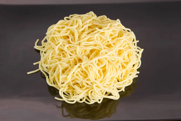 Noodles with different ingredients and excipients on a plate with chopsticks — Stock Photo, Image