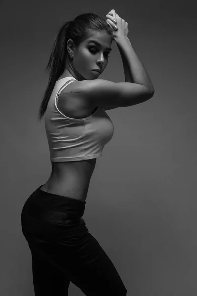 High fashion portrait of young sport woman. Black and white image — Stock Photo, Image