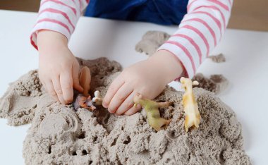 Kız bebek Kinetik kum ile oynamak