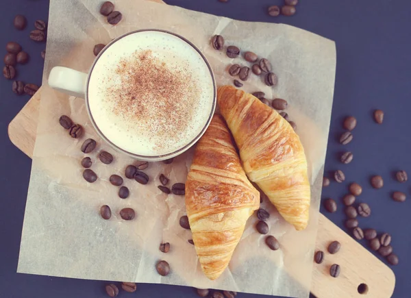 Cup of cappuccino and croissants
